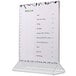 A white Cal-Mil standard acrylic displayette holding a white menu card with black writing.
