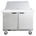 A Beverage-Air stainless steel refrigerated sandwich prep table with two doors and a top shelf.