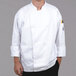 A man wearing a white Chef Revival chef's coat.
