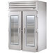 Two True stainless steel reach-in refrigerators with glass doors.