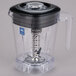 A clear Waring blender jar with a black lid.