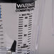 A Waring clear blender jar with a measuring cup on top.