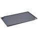 A Lodge rectangular black cast iron griddle with handles.