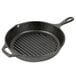 A black round cast iron grill pan.