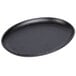A black oval cast iron pan with a handle.