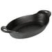 A black Lodge cast iron oval casserole dish with two handles.