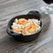 A Lodge mini cast iron bowl of rice with shrimp.