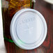 A white plastic lid with a straw slot on a Cambro Laguna tumbler.