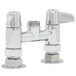 A chrome plated Equip by T&S deck mount faucet base with lever handles.