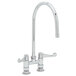 A chrome Equip by T&amp;S deck-mount faucet with wrist action handles and a swing nozzle.