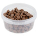 A 12 oz. clear plastic deli container full of chocolate chips with a lid.