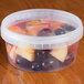 A close-up of a clear plastic deli container filled with fruit.