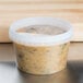 A 16 oz. clear tamper evident deli container of food on a counter.