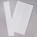 Two white paper strips with black lines hanging from a gray surface.