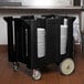 A black Cambro dish dolly with white plates in it.