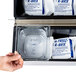 A hand holding a box of 6 Polar Tech Re-Freez-R-Brix foam freeze packs.