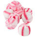 A close up of a group of round pink and white candies.
