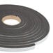 A roll of black foam tape with white backing.