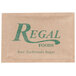 A close-up of a Regal Raw Turbinado Sugar packet with a green logo on a tan surface.