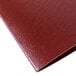 A close-up of a burgundy leather Menu Solutions wine list cover.