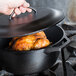 A cooked chicken in a Lodge cast iron Dutch oven.