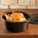 A Lodge cast iron Dutch oven with chicken in it.