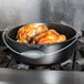 A cooked chicken in a Lodge cast iron Dutch oven.
