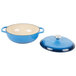 A Caribbean blue enameled cast iron Lodge Dutch oven with a white interior and lid.