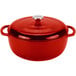 A Lodge Island Spice Red enameled cast iron dutch oven with a lid.