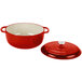 A red and white enameled cast iron pot with lid.