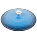 A Caribbean blue Lodge enameled cast iron casserole dish with a metal lid with a white rim.
