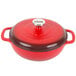 A Lodge Island Spice Red Enameled Cast Iron Dutch Oven with a lid.