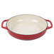 A red and white Lodge enameled cast iron casserole dish with handles.