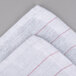 A red and white striped Chef Revival glass polishing towel.