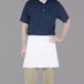 A man wearing a white Chef Revival waist apron.