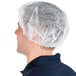 A man wearing a Chef Revival white disposable polypropylene hair net.