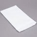 A folded white Choice flour sack towel on a gray surface.