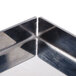 A close up of the metal corners of a square reflector for a Nemco countertop pizza oven.