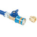 A blue and gold Dormont gas connector hose with brass fittings.