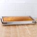 A Baker's Mark full-size sheet pan with a loaf of bread in it on a counter.