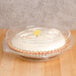 A close-up of a pie in a Polar Pak plastic container with a low dome lid.