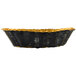 A black and gold Thunder Group oval rattan basket with a handle.