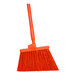 A close-up of a Carlisle Sparta Duo-Sweep broom with orange unflagged bristles and a handle.