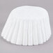 A white round coffee filter with ruffled edges.