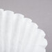 A white Grindmaster coffee filter.
