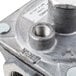 A close-up of a Dormont RV48CL-32 metal gas regulator piece with a metal nut.
