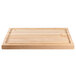 A Nemco wooden carving board on a wood surface.