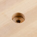 A hole in a wooden carving board.