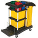 A Rubbermaid cleaning cart with three yellow and black plastic containers.
