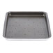 A grey square baking tray liner with black dots.